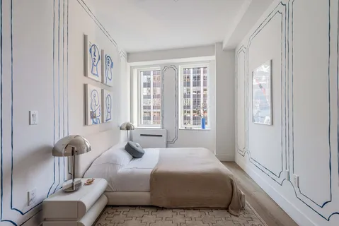 a bedroom with a bed and glass windows