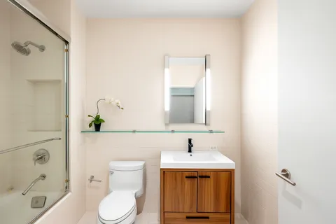 a bathroom with a sink toilet and shower