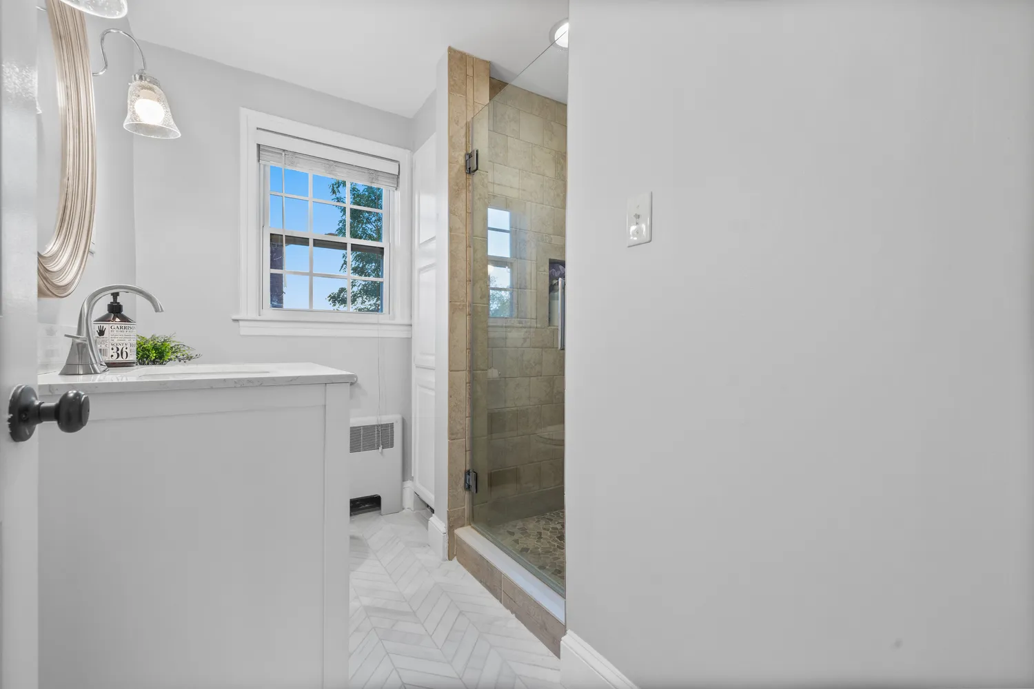 a bathroom with a shower sink and mirror