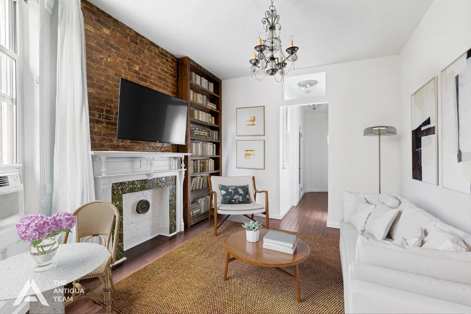 a living room with furniture a flat screen tv and a fireplace
