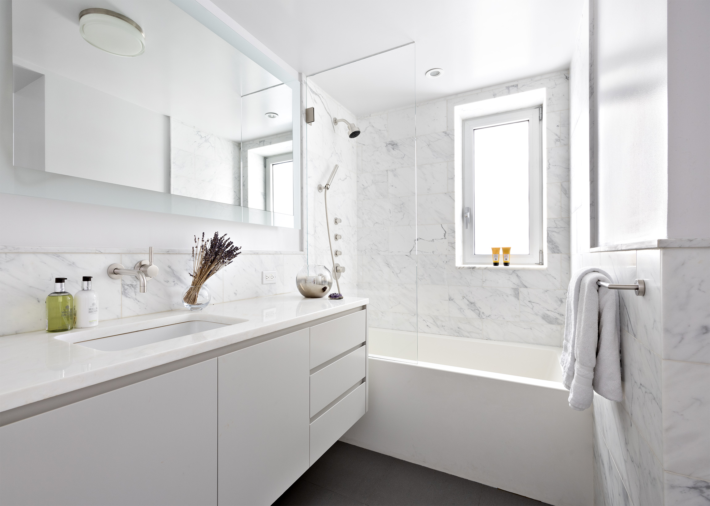 45 East 72nd Street, Unit 9BC Manhattan, NY 10021 - Photo 11 of 16 a bathroom with a tub sink and mirror