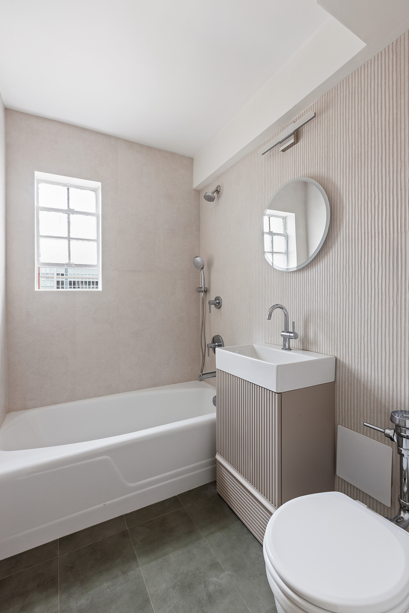 335 East 51st Street, Unit 9D Manhattan, NY 10022 - Photo 10 of 14 a bathroom with a toilet a sink and bathtub