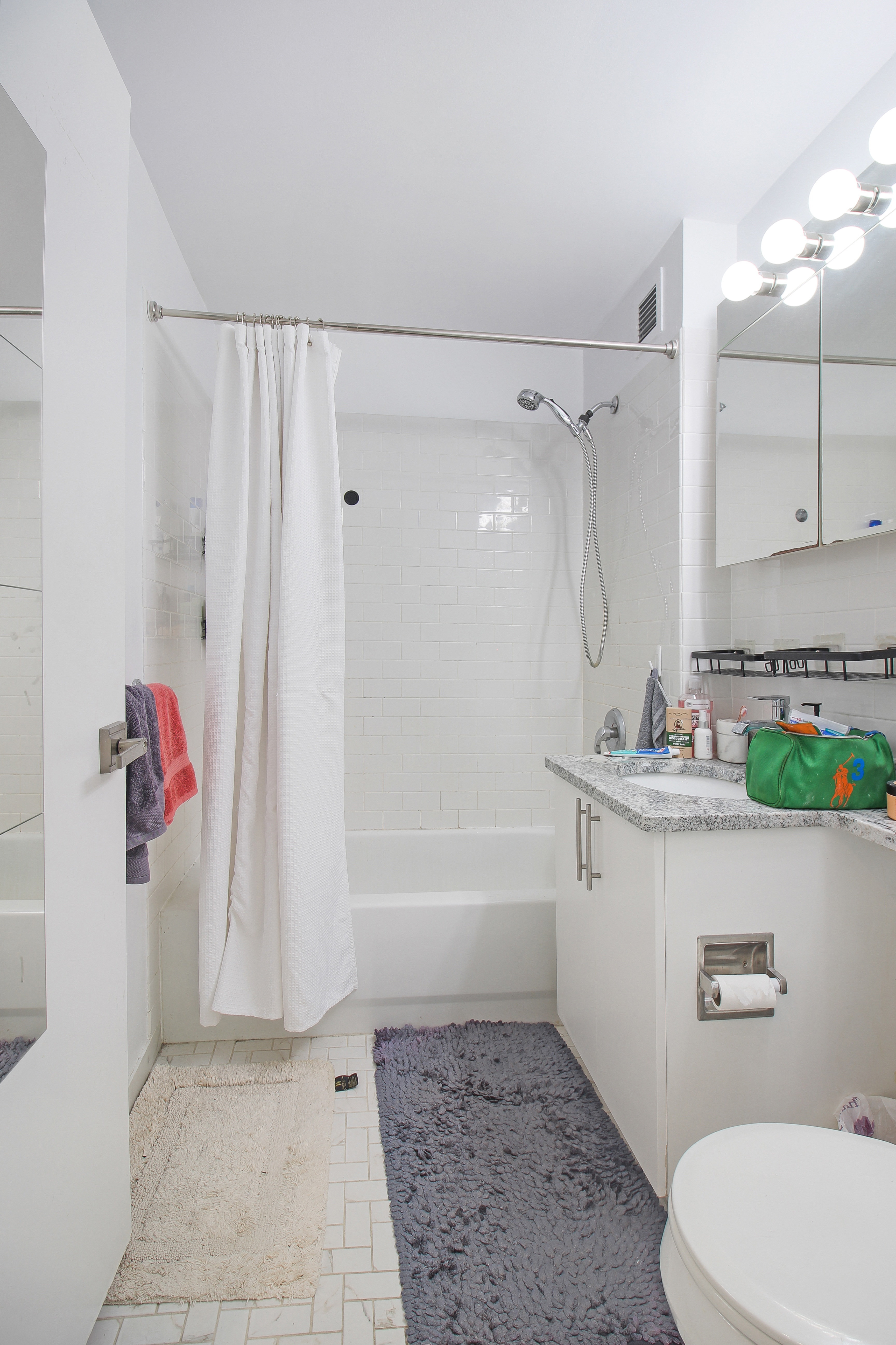 199 Bowery, Unit 2B Manhattan, NY 10002 - Photo 4 of 12 a bathroom with a sink a toilet and shower