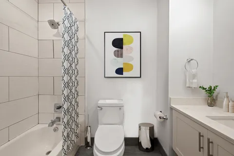 a bathroom with a toilet sink and shower