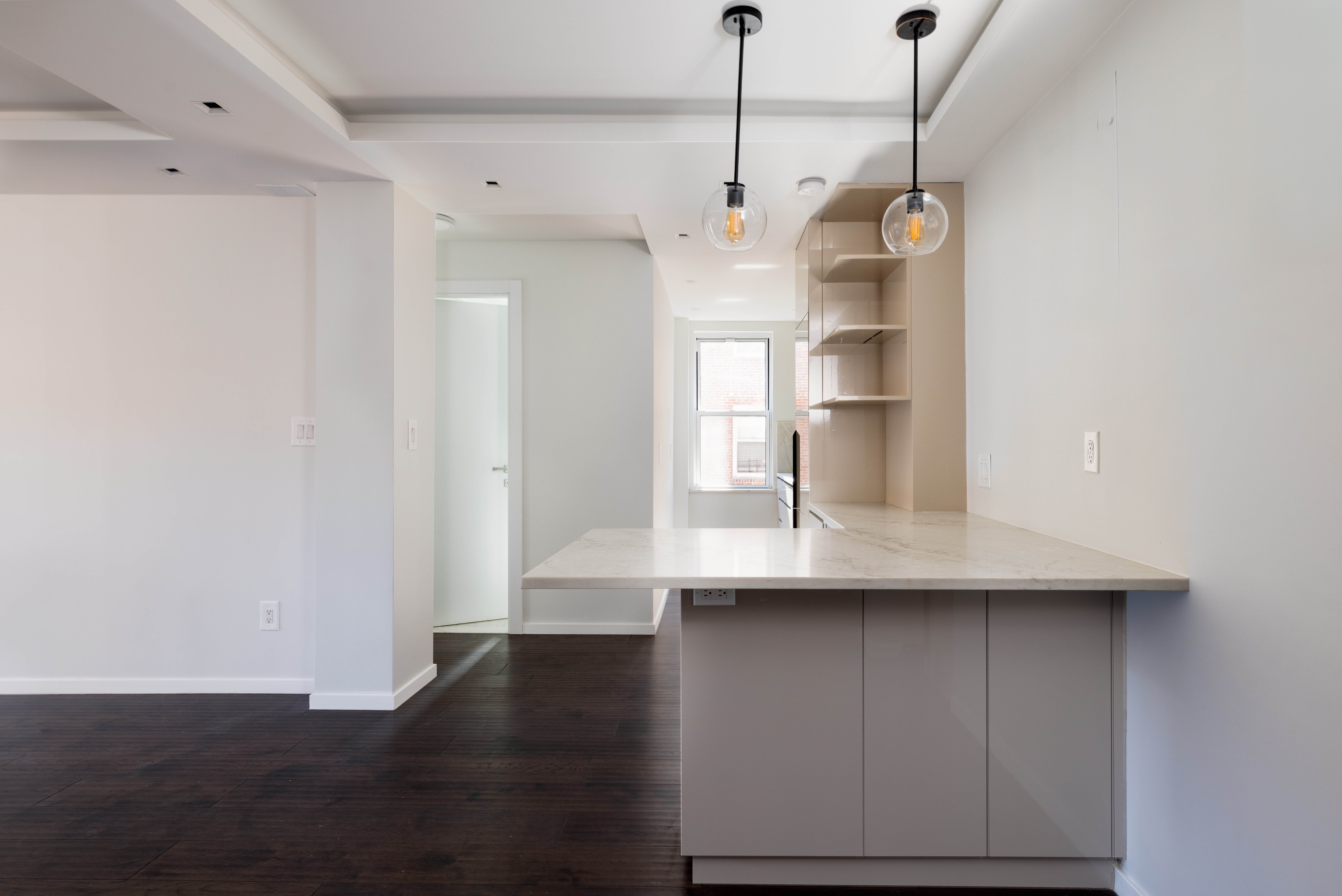 71-36 110th Street, Unit 4C Queens, NY 11375 - Photo 6 of 14 a kitchen with kitchen island white cabinets and stainless steel appliances