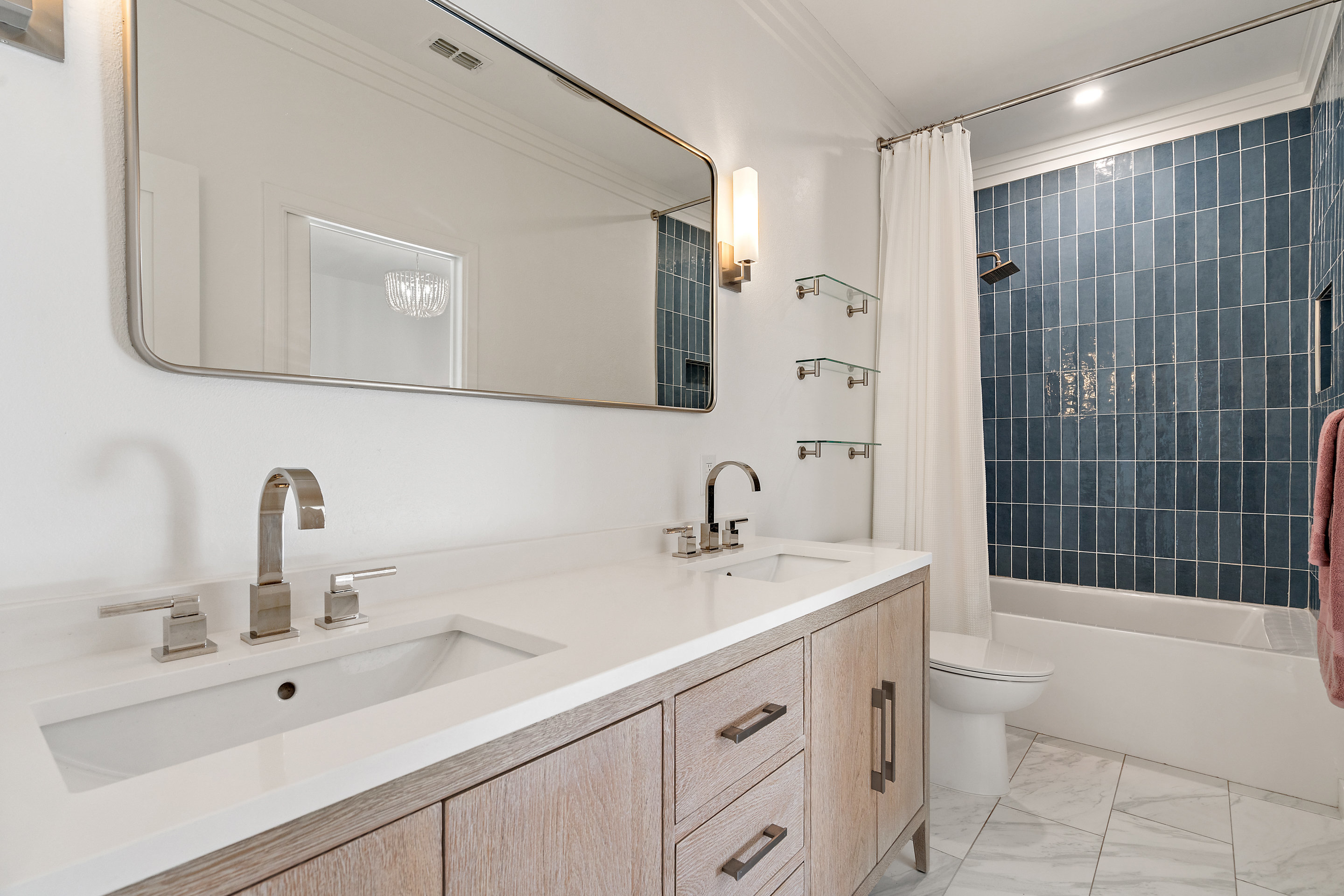 5319 Backtrail Drive Austin, TX 78731 - Photo 30 of 35 a bathroom with a double vanity sink toilet mirror and shower