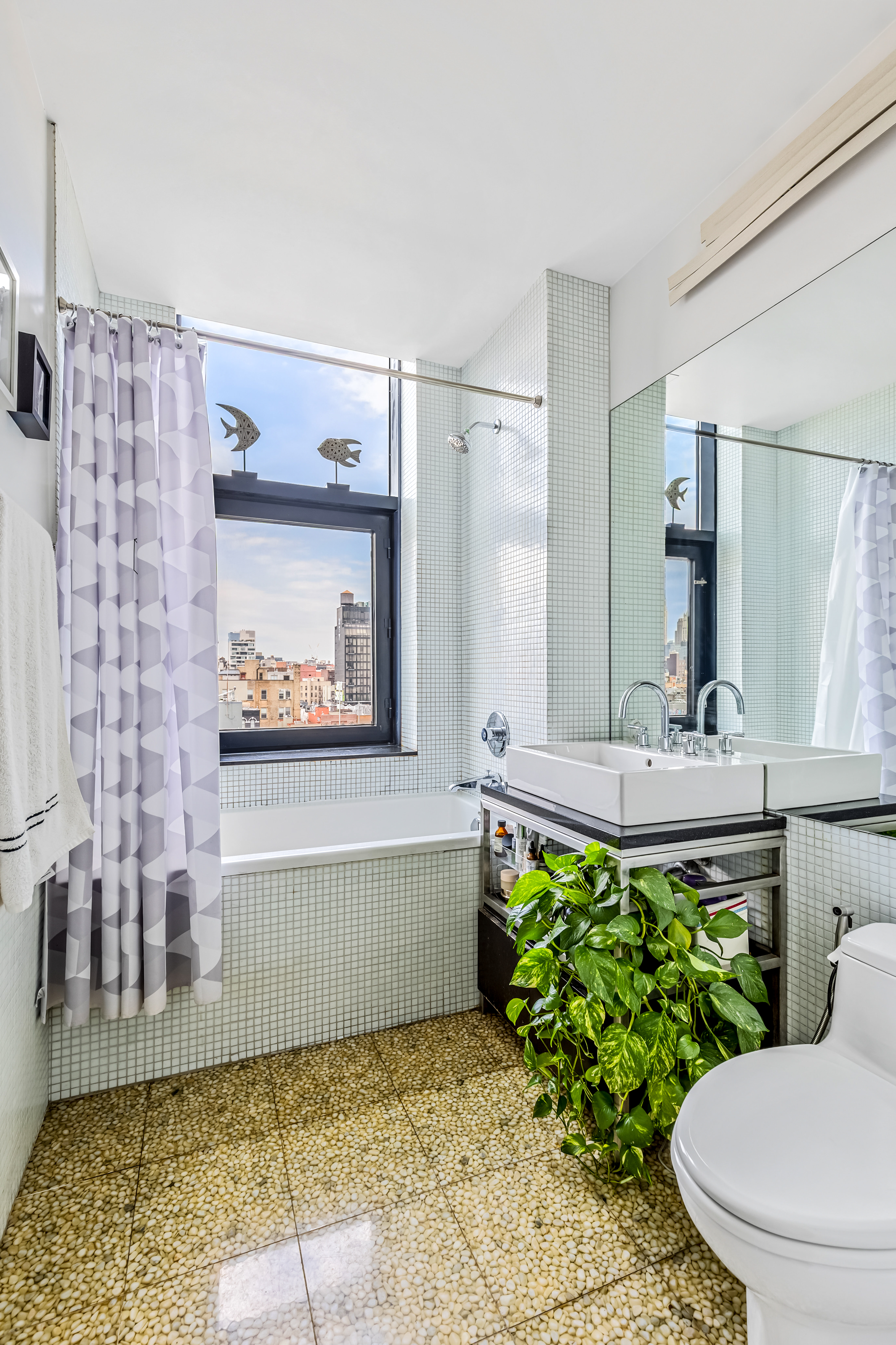 105 Norfolk Street, Unit 10A Manhattan, NY 10002 - Photo 7 of 11 a bathroom with a bathtub and a shower