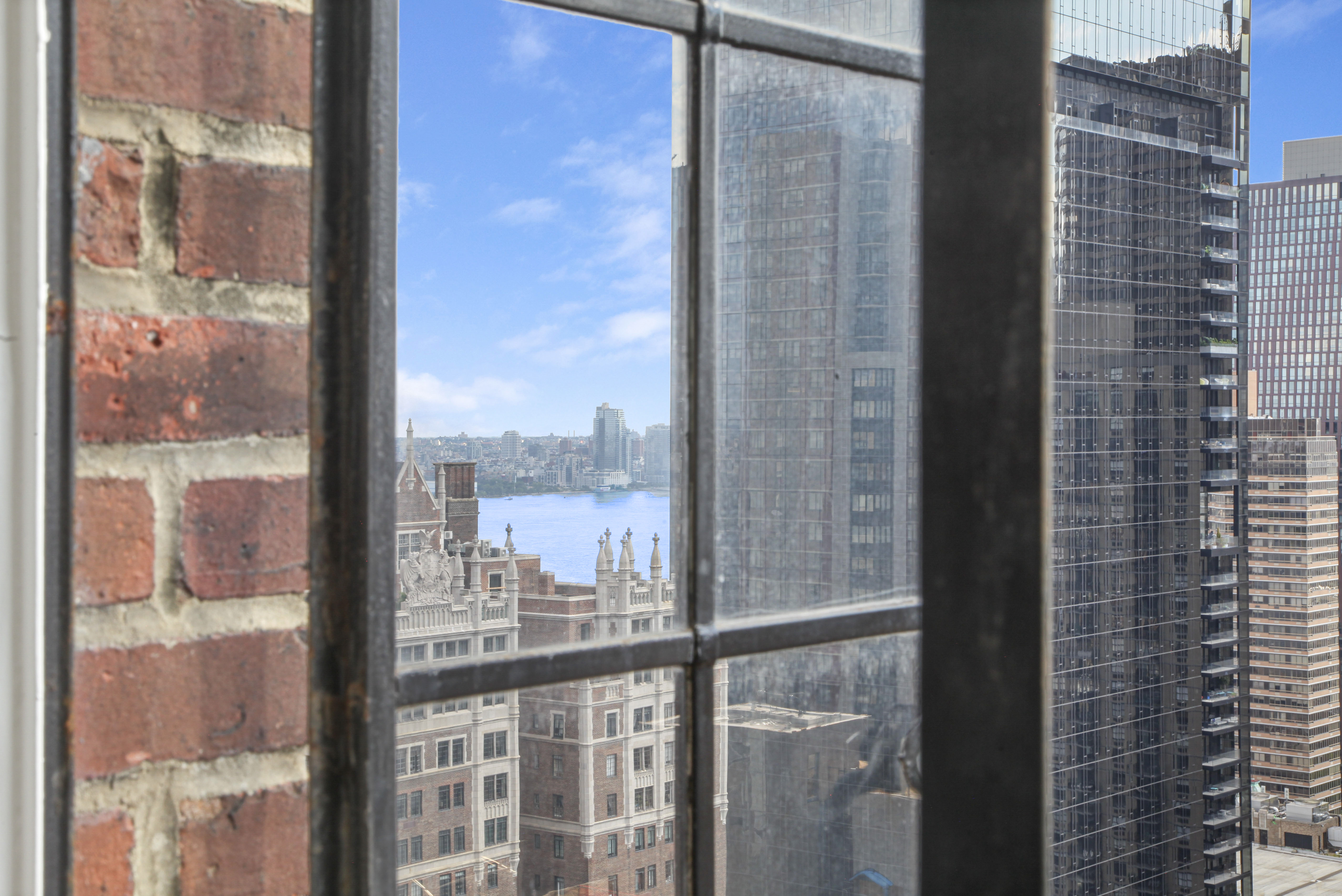 320 East 42nd Street, Unit 3012 Manhattan, NY 10017 - Photo 4 of 12 a view of a glass building from a glass door