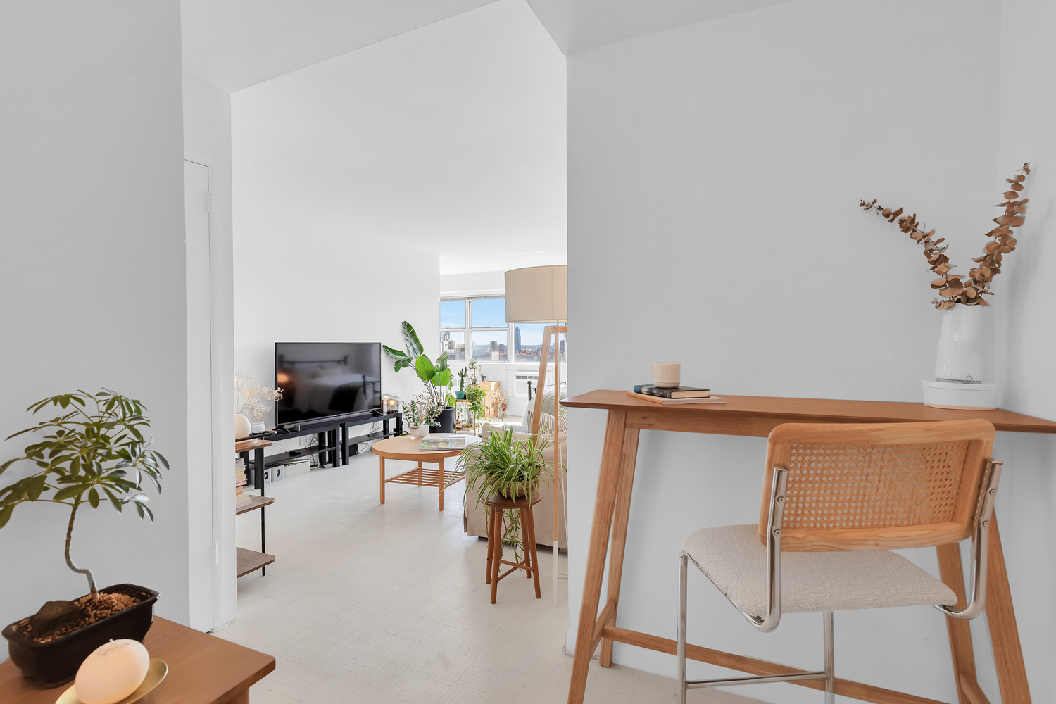 111 3rd Avenue, Unit 17G Manhattan, NY 10003 - Photo 6 of 9 a living room with furniture a potted plant and a fireplace