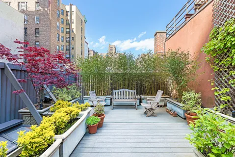 a view of balcony with couch and potted plants