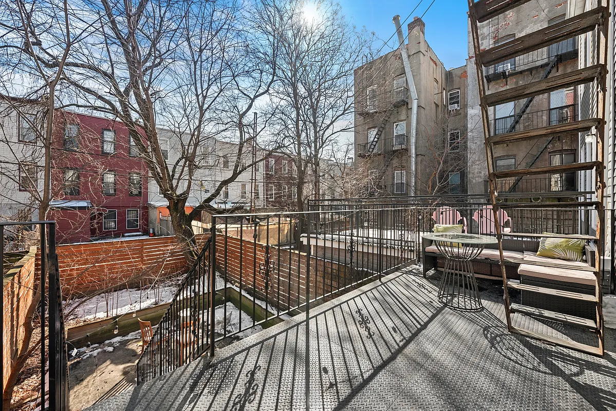 1316 Jefferson Avenue, Unit 2 Brooklyn, NY 11221 - Photo 8 of 10 a view of a roof deck with couches and wooden fence