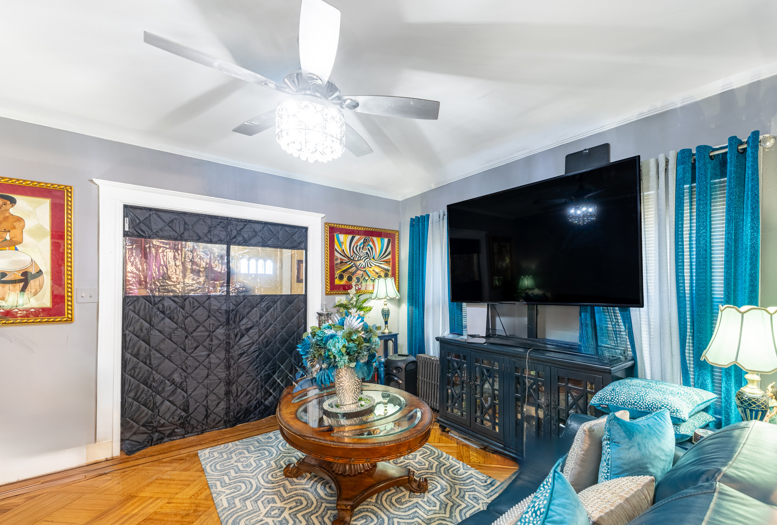 961 East 32nd Street Brooklyn, NY 11210 - Photo 4 of 24 a living room with furniture and a flat screen tv