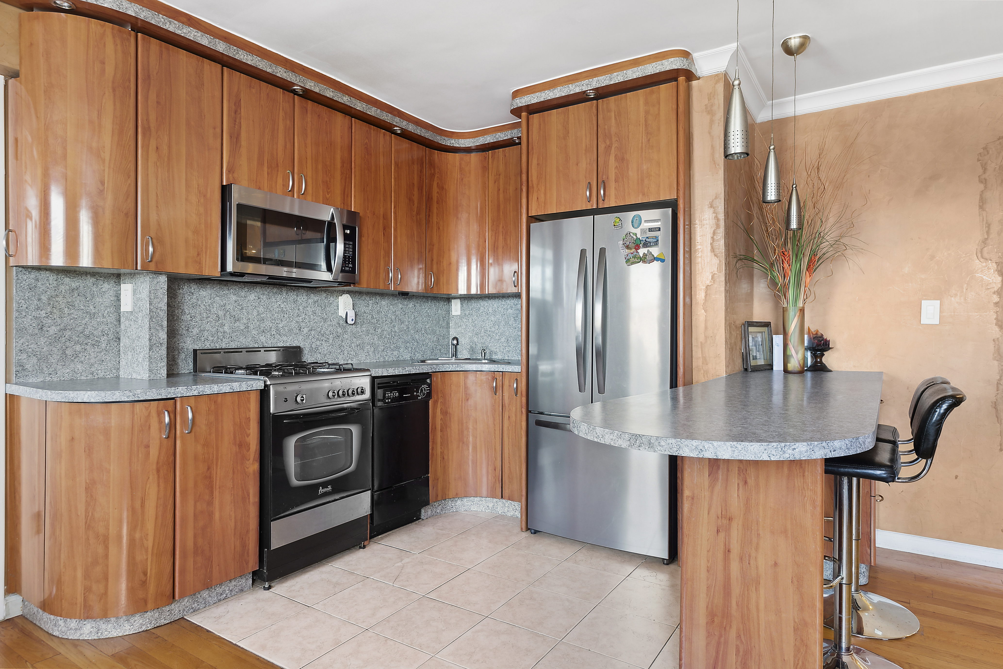 9602 4th Avenue, Unit 4P Brooklyn, NY 11209 - Photo 3 of 6 a kitchen with stainless steel appliances granite countertop a refrigerator a stove a sink and a microwave