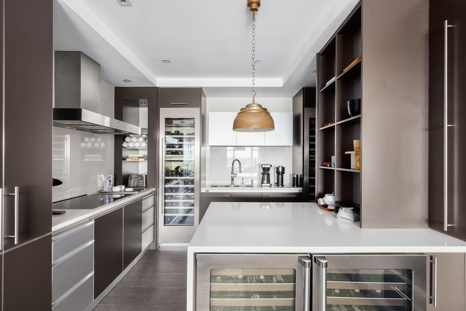 a kitchen with a sink a stove cabinets and wooden floor