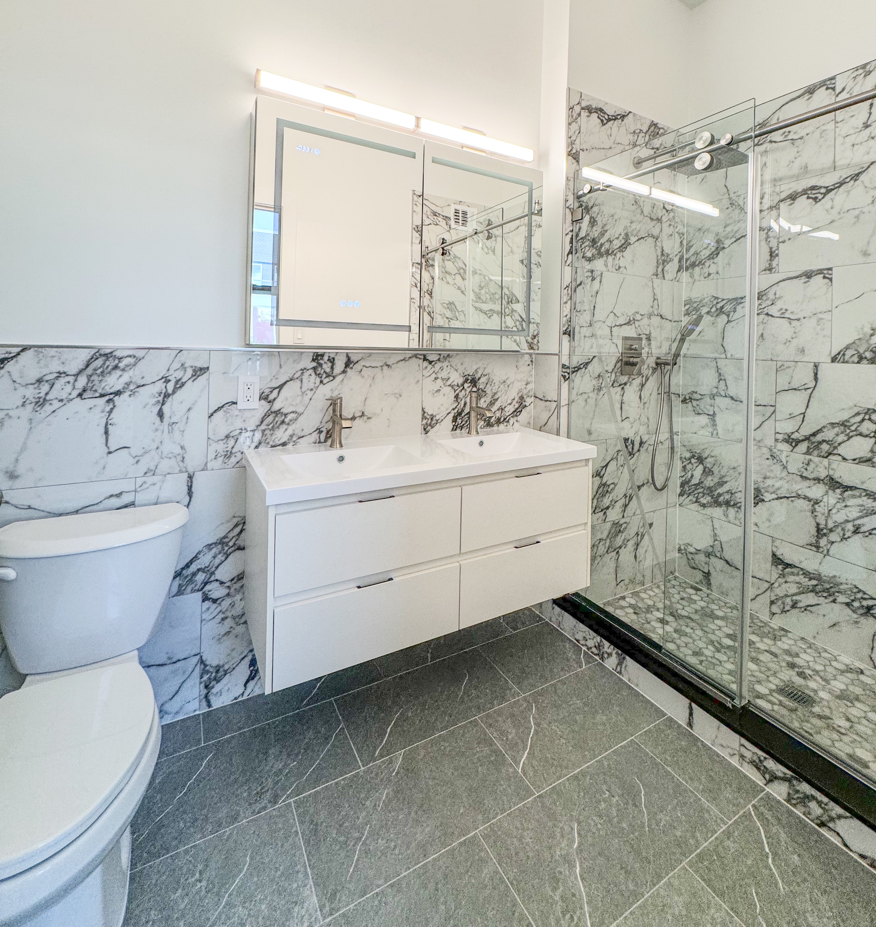 44 Berry Street, Unit 4J Brooklyn, NY 11249 - Photo 5 of 8 a bathroom with a sink a toilet and shower