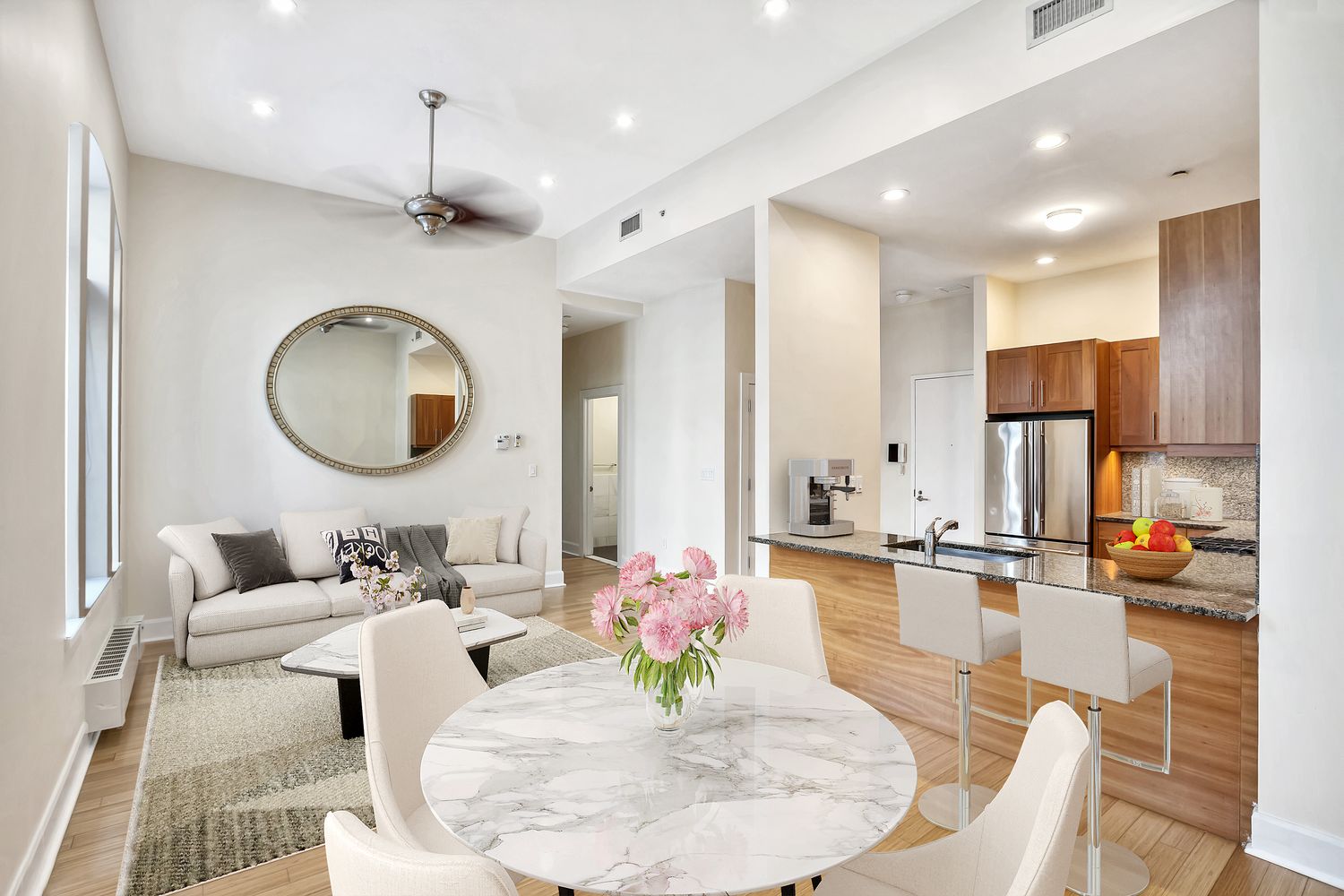 2056 5th Avenue, Unit 2B Manhattan, NY 10035 - Photo 2 of 13 a living room with kitchen island furniture and a chandelier