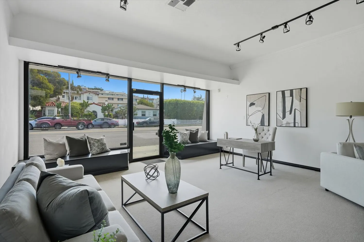 a living room with furniture and a floor to ceiling window