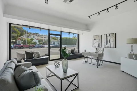a living room with furniture and a floor to ceiling window