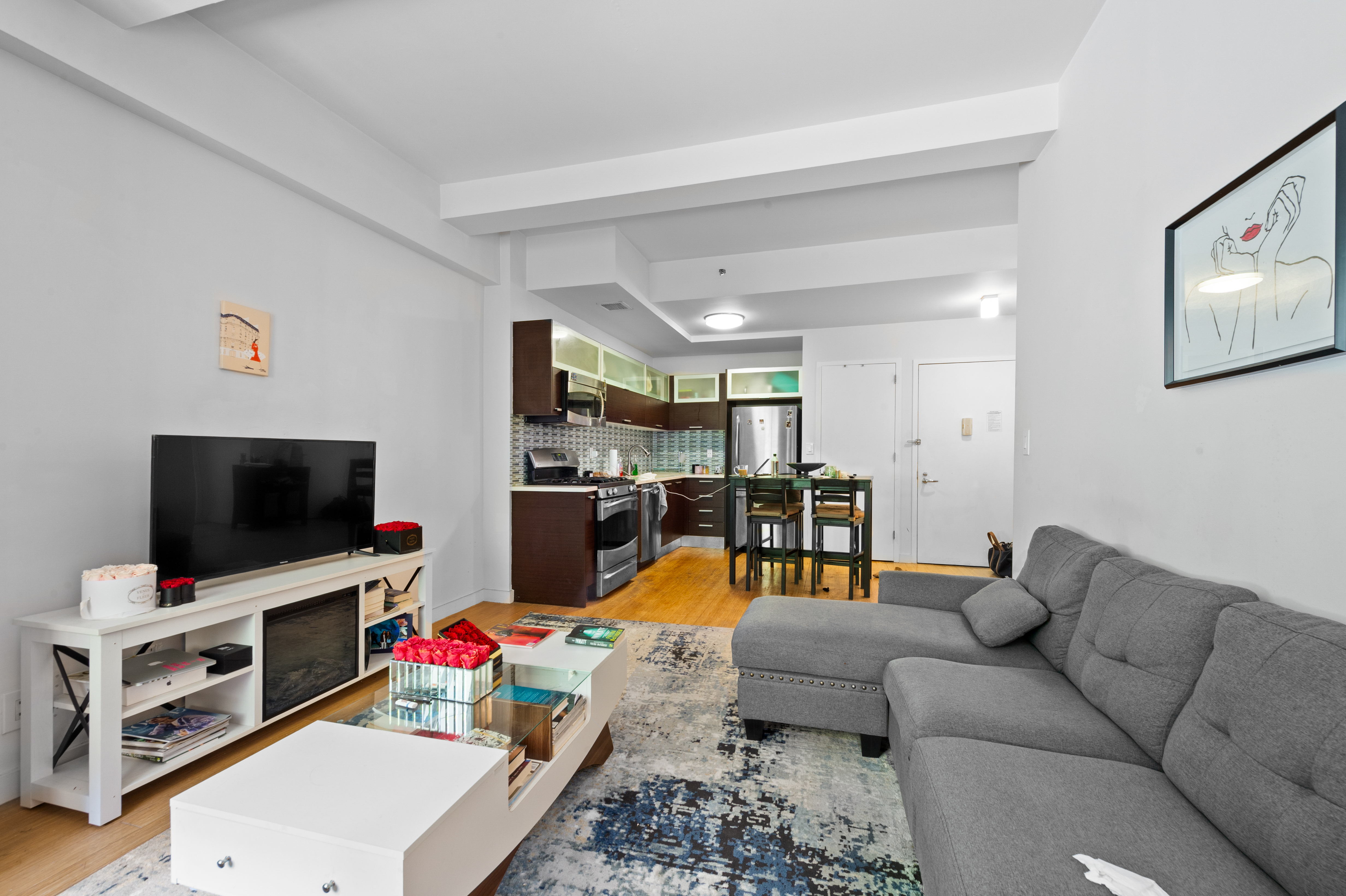 a living room with furniture and a flat screen tv