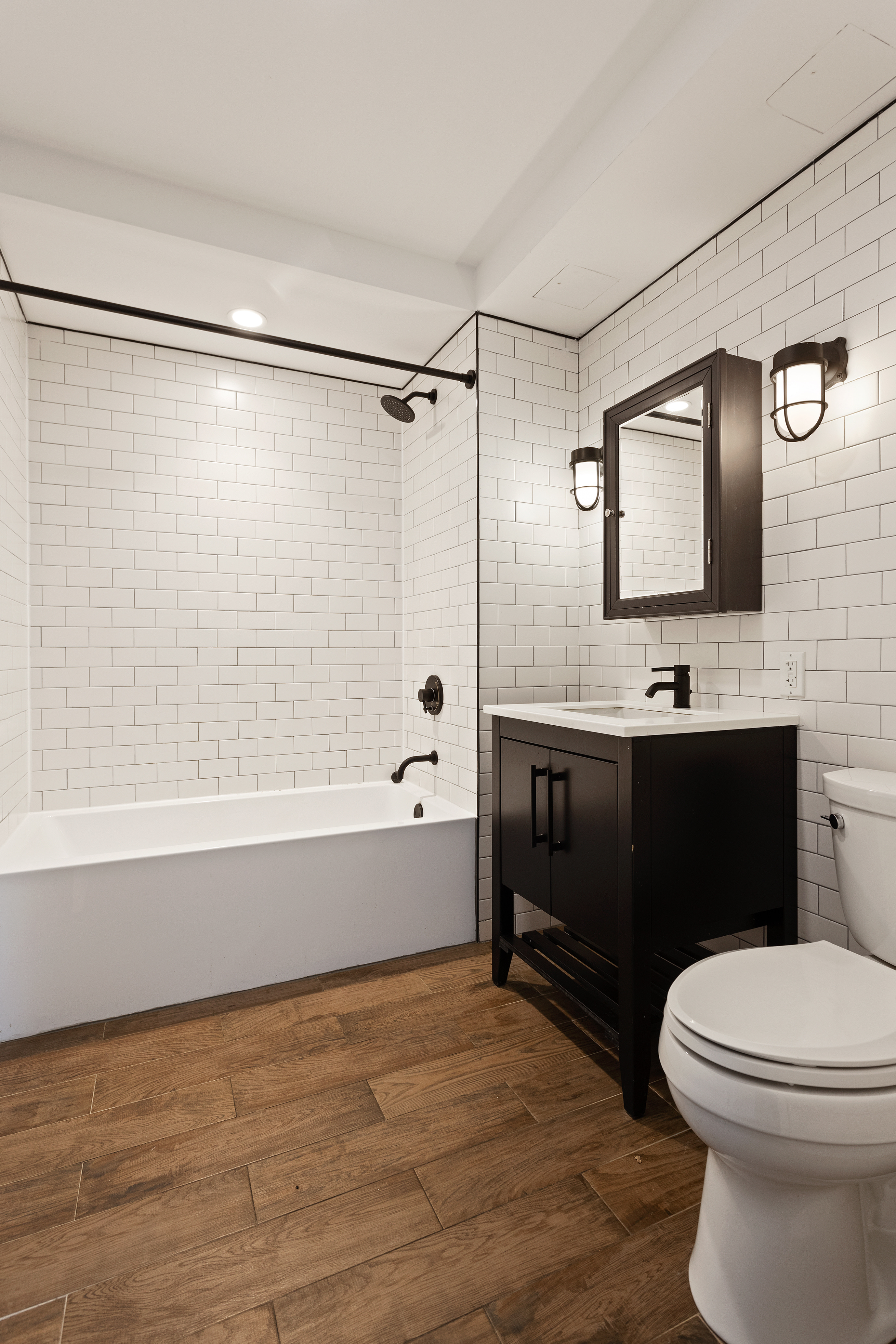 16-26 Madison Street, Unit PHA Queens, NY 11385 - Photo 5 of 16 a bathroom with a sink a toilet and shower