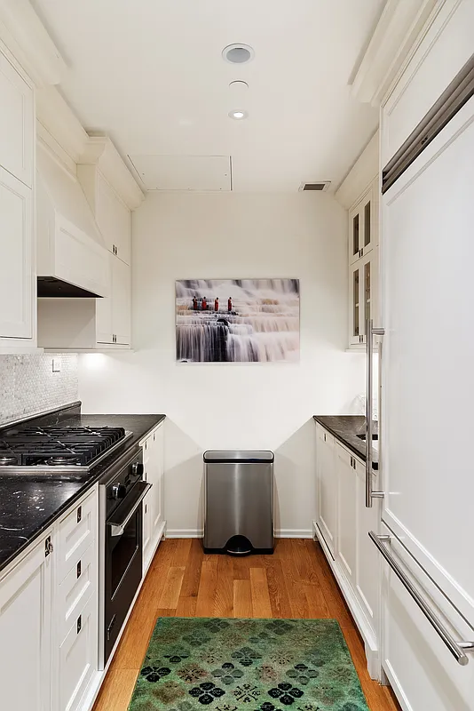1 Central Park South, Unit 8010203 Manhattan, NY 10019 - Photo 40 of 45 a kitchen with a stove and a refrigerator