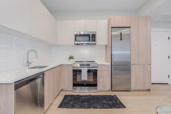 a kitchen with a stove and a refrigerator
