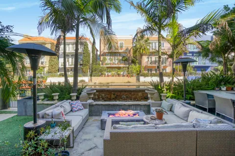 a view of a fountain with a fire pit and swimming pool