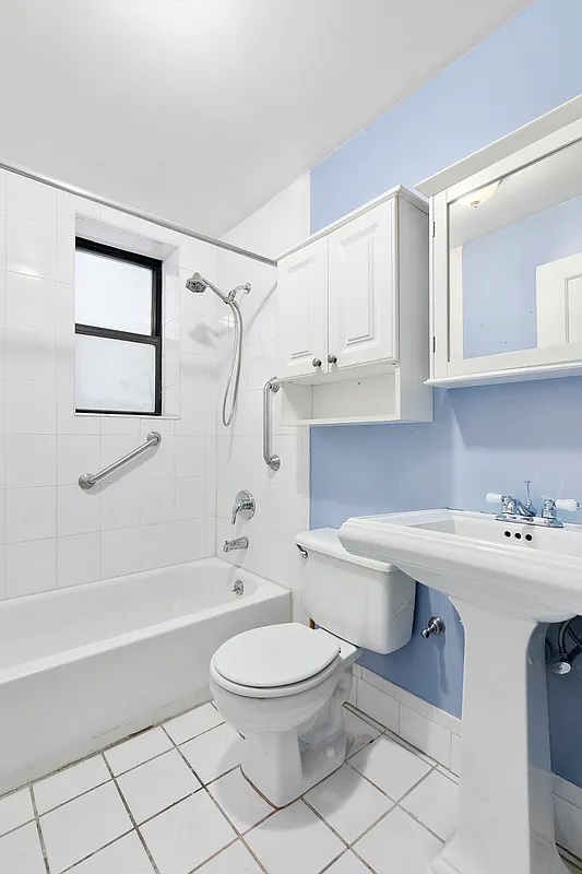 4 West 109th Street, Unit 4F Manhattan, NY 10025 - Photo 10 of 16 a bathroom with a sink a toilet and shower
