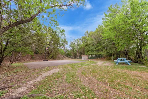 a backyard of a house with table and chairs