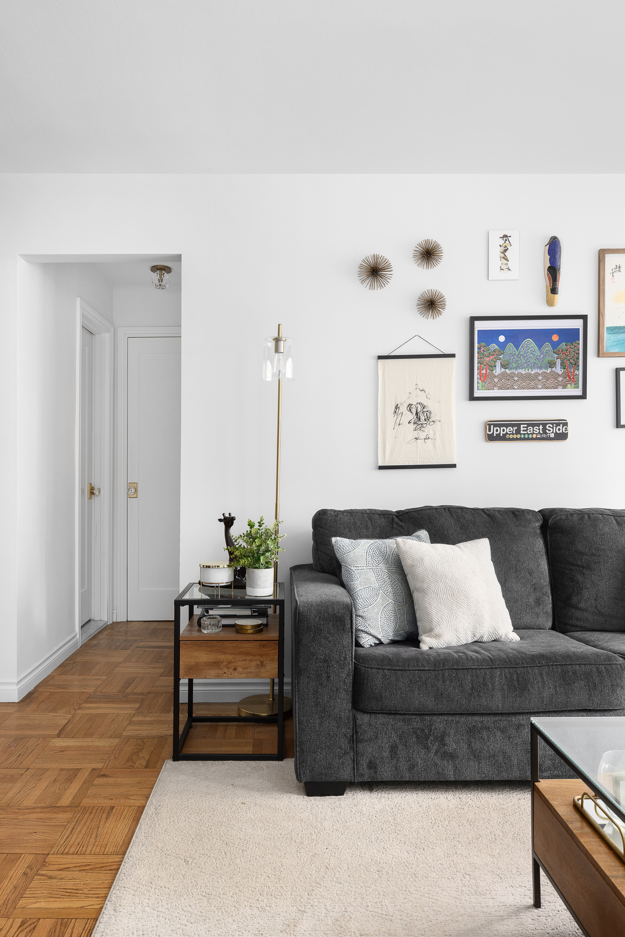 333 East 66th Street, Unit 8C Manhattan, NY 10065 - Photo 7 of 13 a living room with furniture and wooden floor