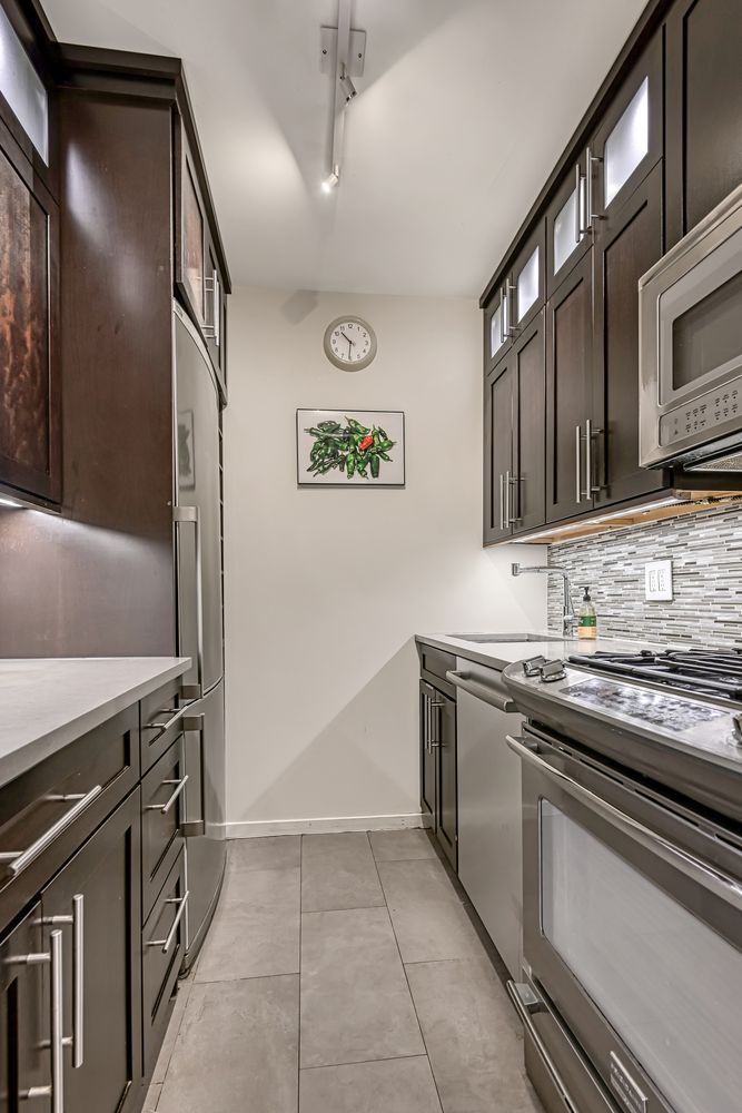 a kitchen with stainless steel appliances granite countertop a stove and a sink