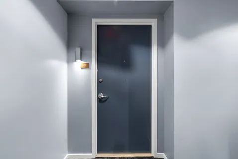 a living room with furniture and a lamp