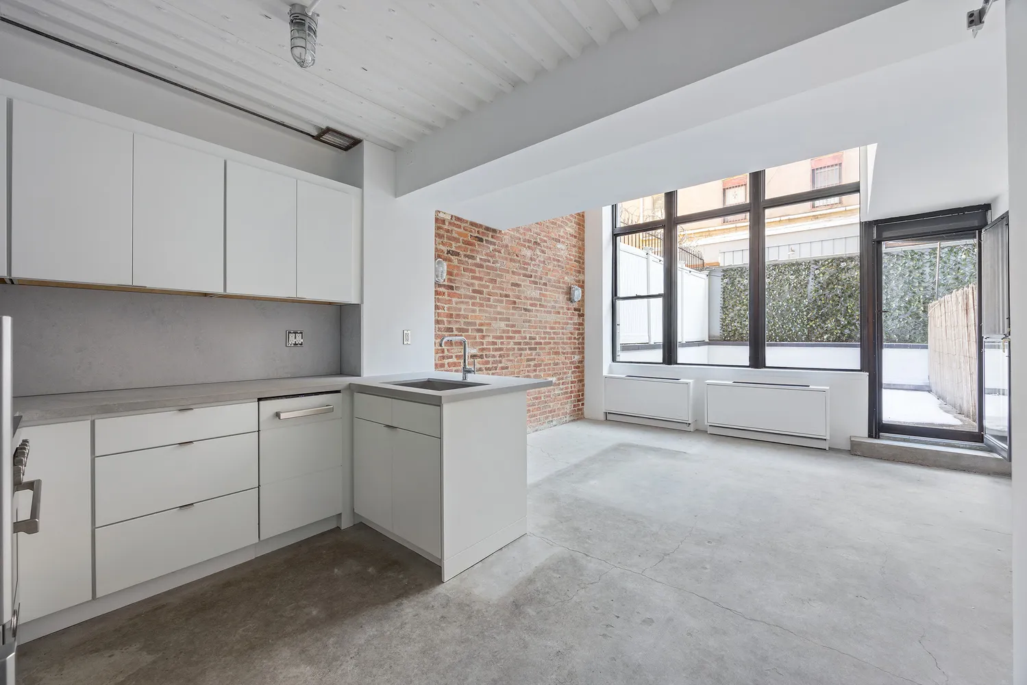 a view of a kitchen with dishwasher and white cabinets