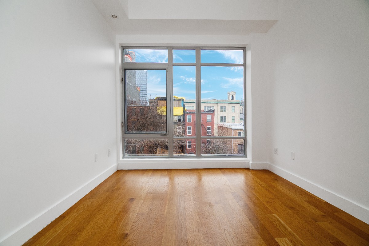 659 Bergen Street, Unit 3D Brooklyn, NY 11238 - Photo 4 of 7 wooden floor in an empty room with a window