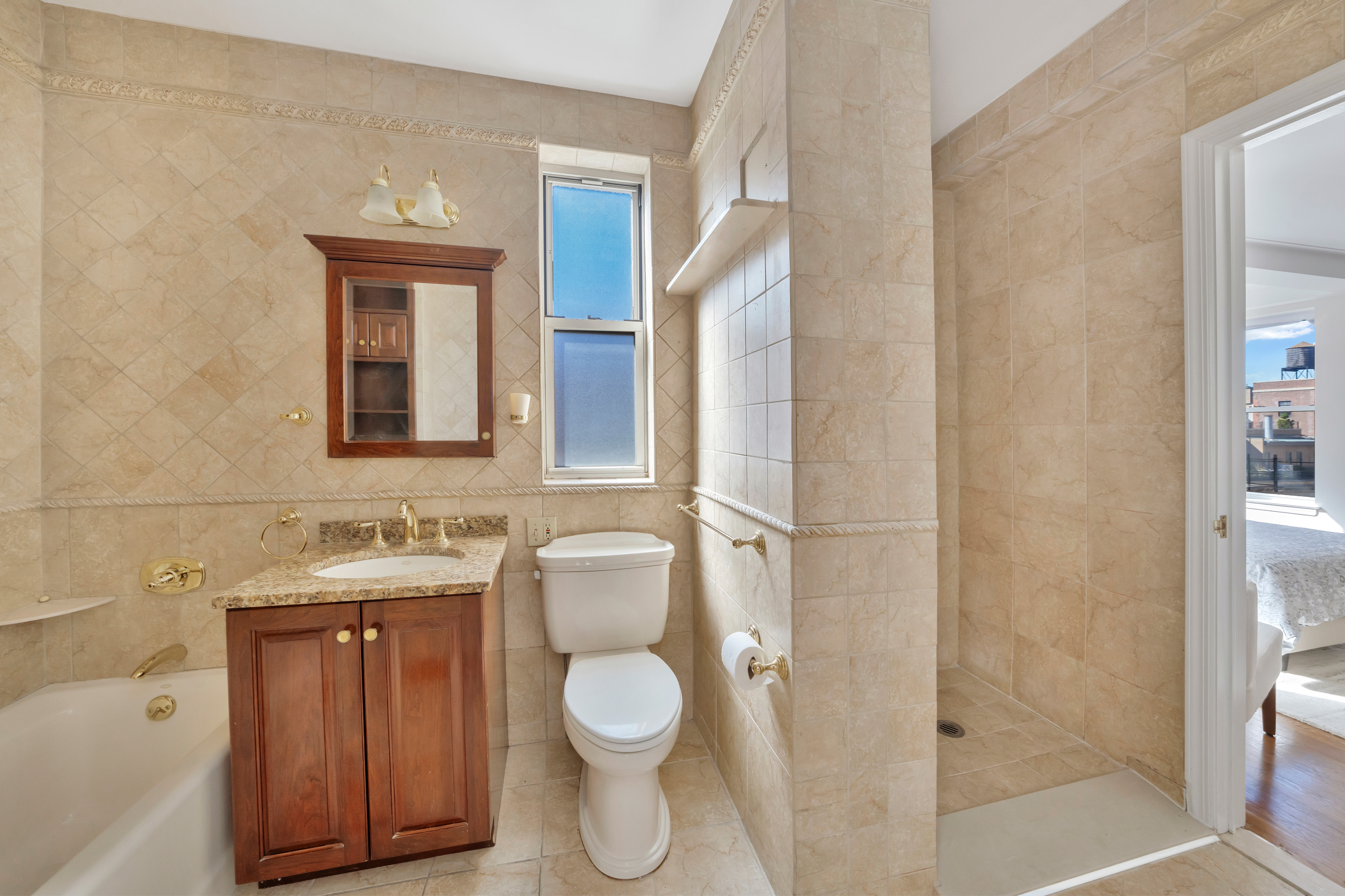 47 East 88th Street, Unit 15A Manhattan, NY 10128 - Photo 12 of 21 a bathroom with a toilet sink and shower