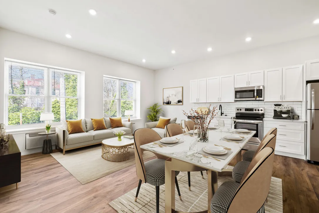 a kitchen with stainless steel appliances a white stove top oven a sink dishwasher and a refrigerator with wooden floors