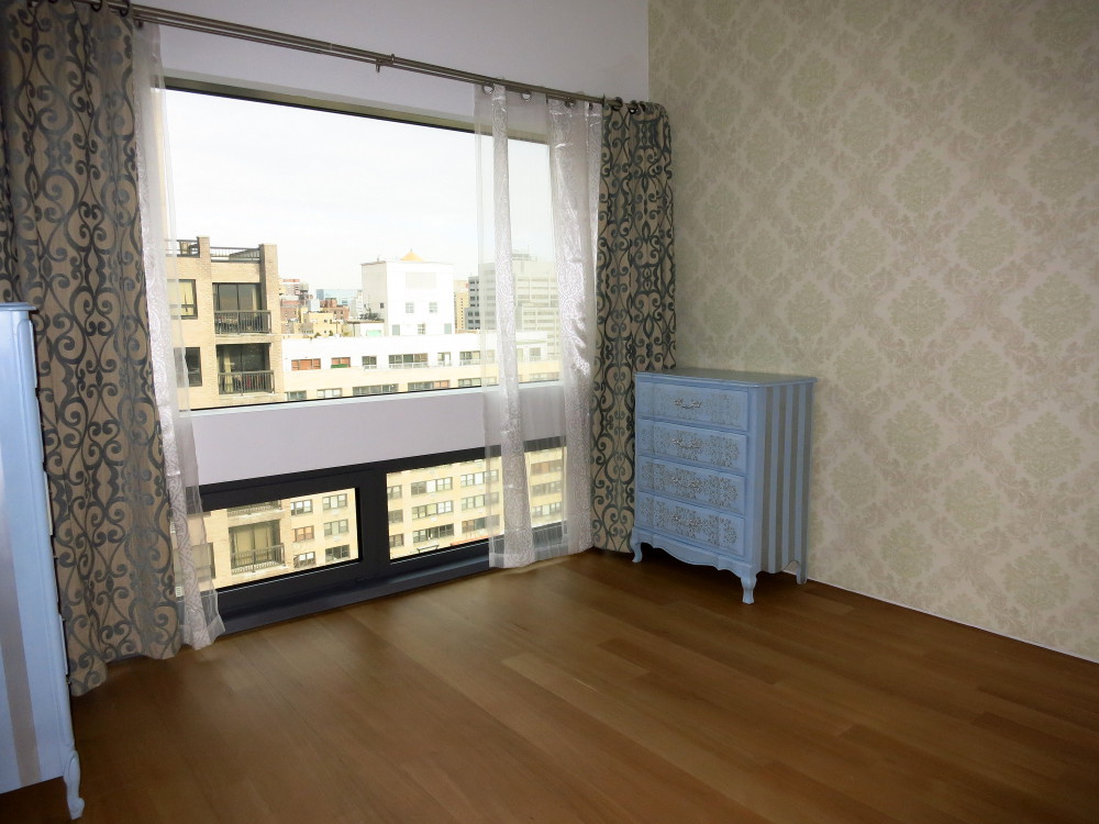 123 3rd Avenue, Unit 12B Manhattan, NY 10003 - Photo 4 of 6 a view of an empty room with a window and wooden floor