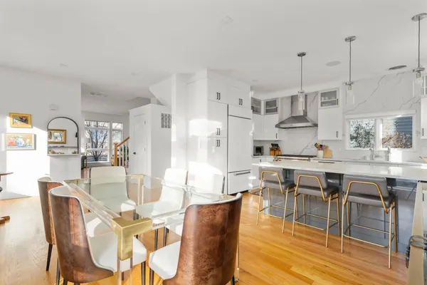 a dining room with stainless steel appliances kitchen island granite countertop a dining table chairs and view living room