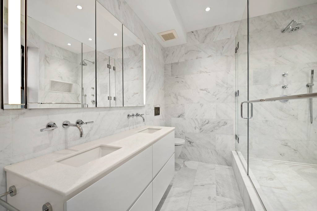 214 Clinton Street, Unit 2E Brooklyn, NY 11201 - Photo 6 of 11 a bathroom with a sink and mirror