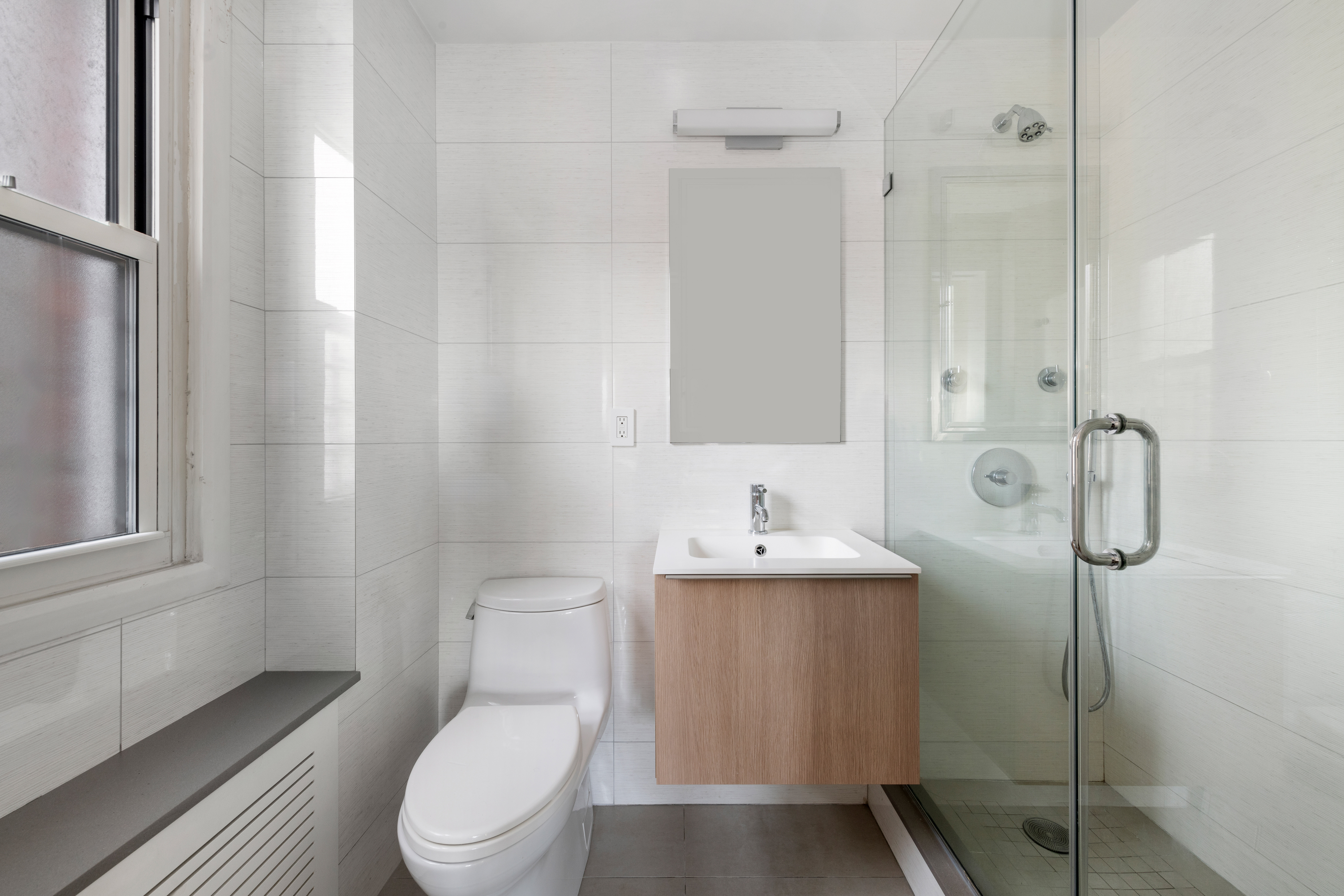 363 East 76th Street, Unit 7C Manhattan, NY 10021 - Photo 11 of 19 a bathroom with a toilet a sink a mirror and vanity