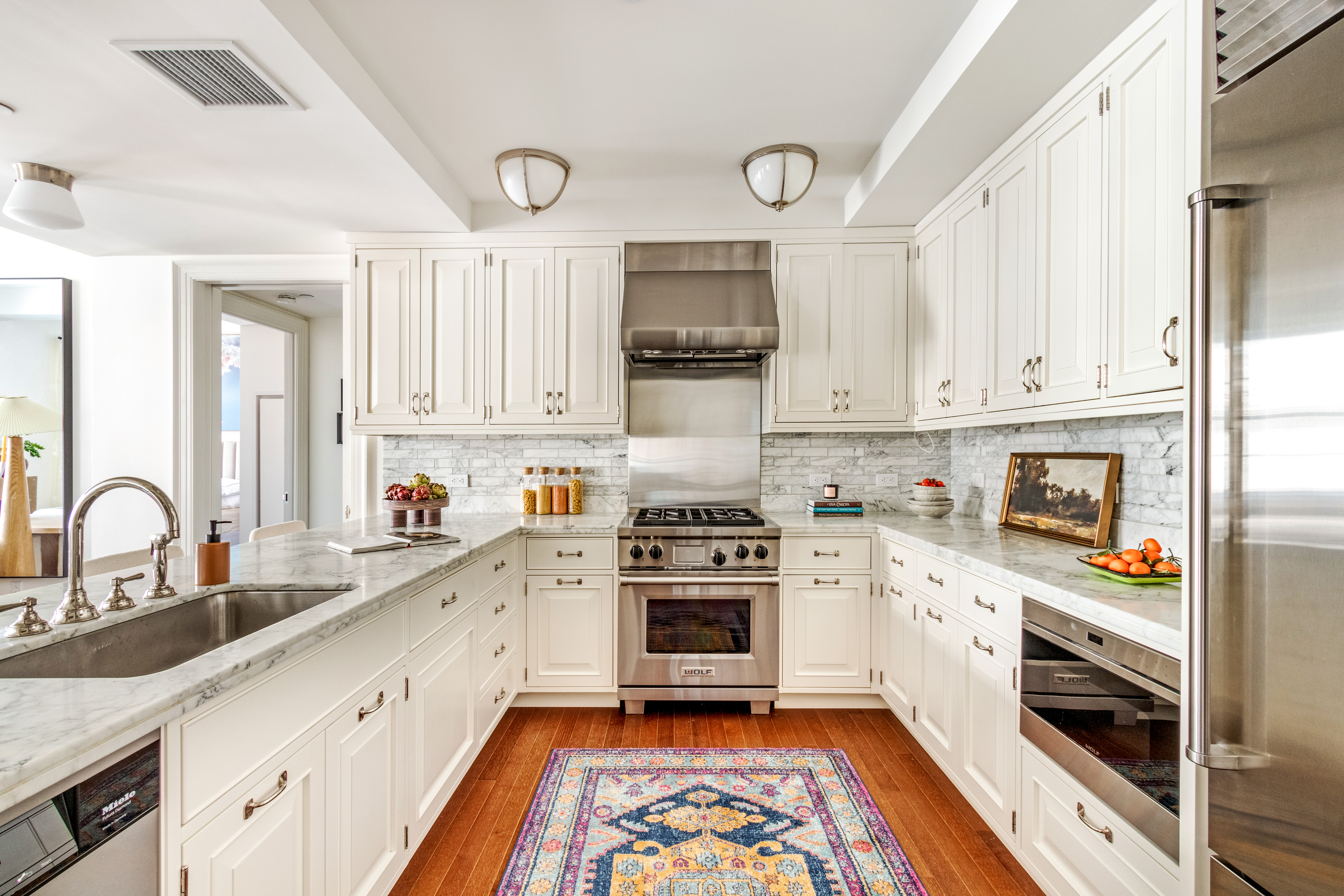 160 West 12th Street, Unit 56 Manhattan, NY 10011 - Photo 3 of 18 a kitchen with granite countertop a stove top oven sink and cabinets