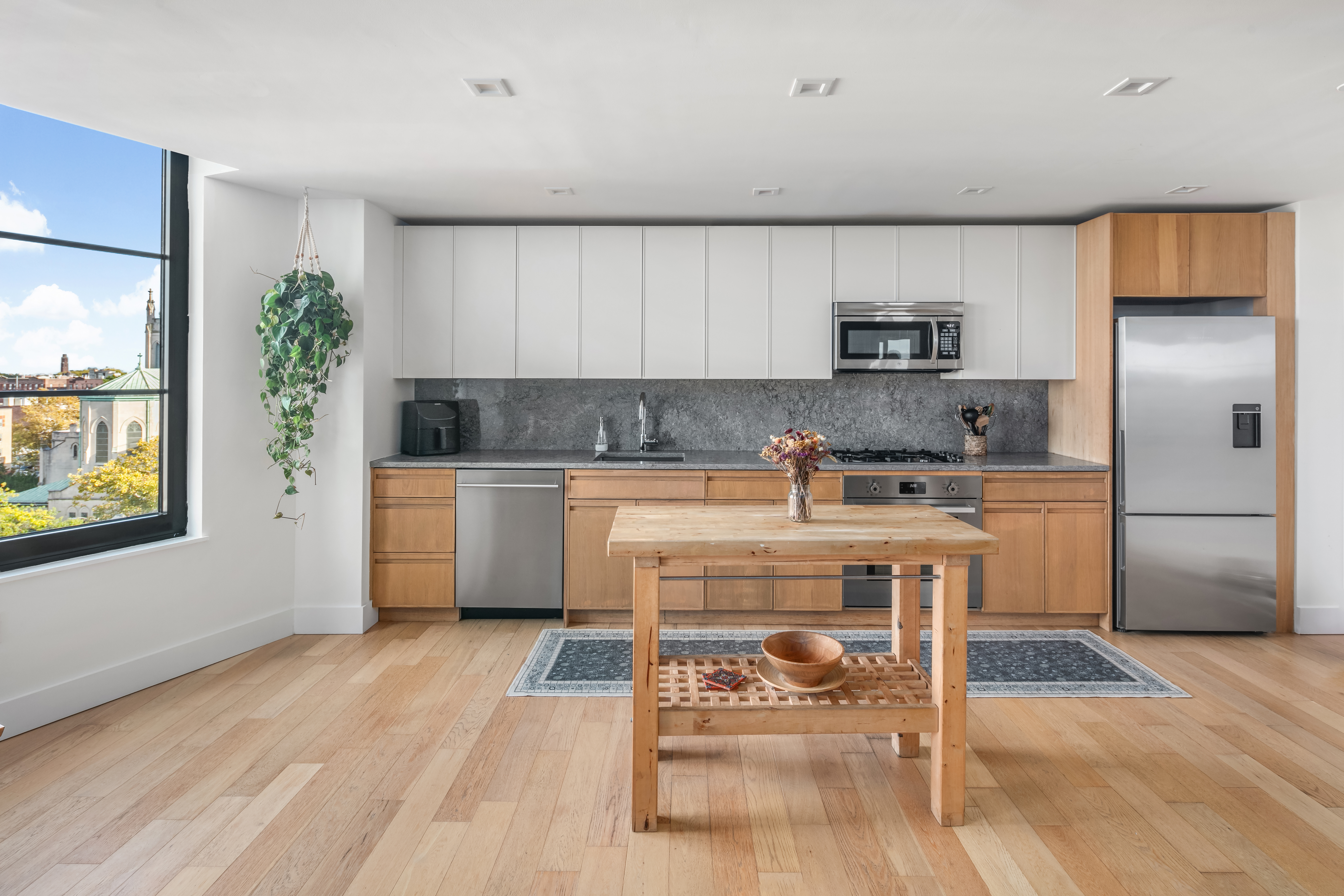 264 Webster Avenue, Unit PH811 Brooklyn, NY 11230 - Photo 2 of 14 a kitchen with a white cabinets and chairs in it
