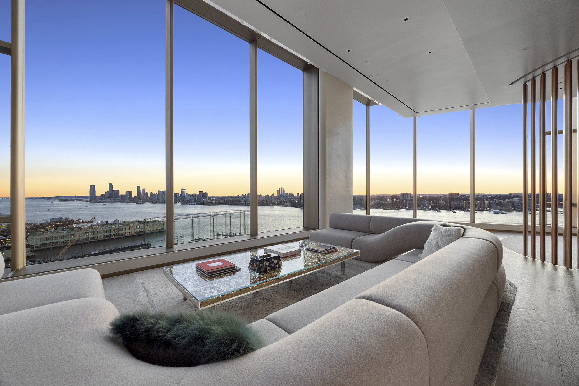 a living room with furniture and a floor to ceiling window
