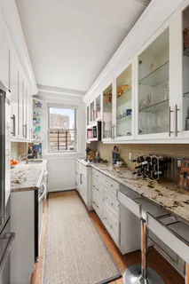a kitchen with stainless steel appliances a sink stove and cabinets