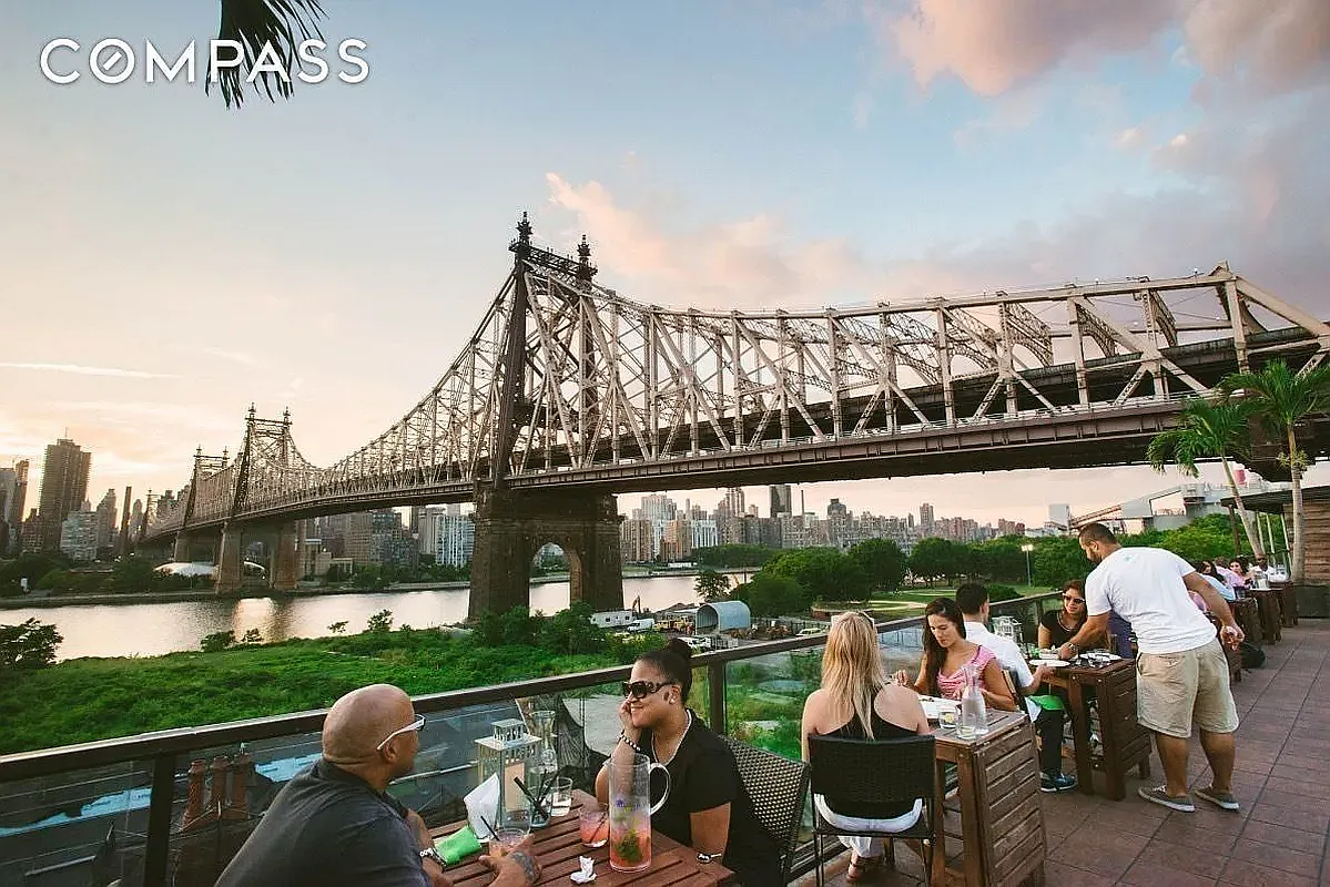 46-09 11th Street, Unit 4H Queens, NY 11101 - Photo 11 of 13 a front view of a house with garden and patio
