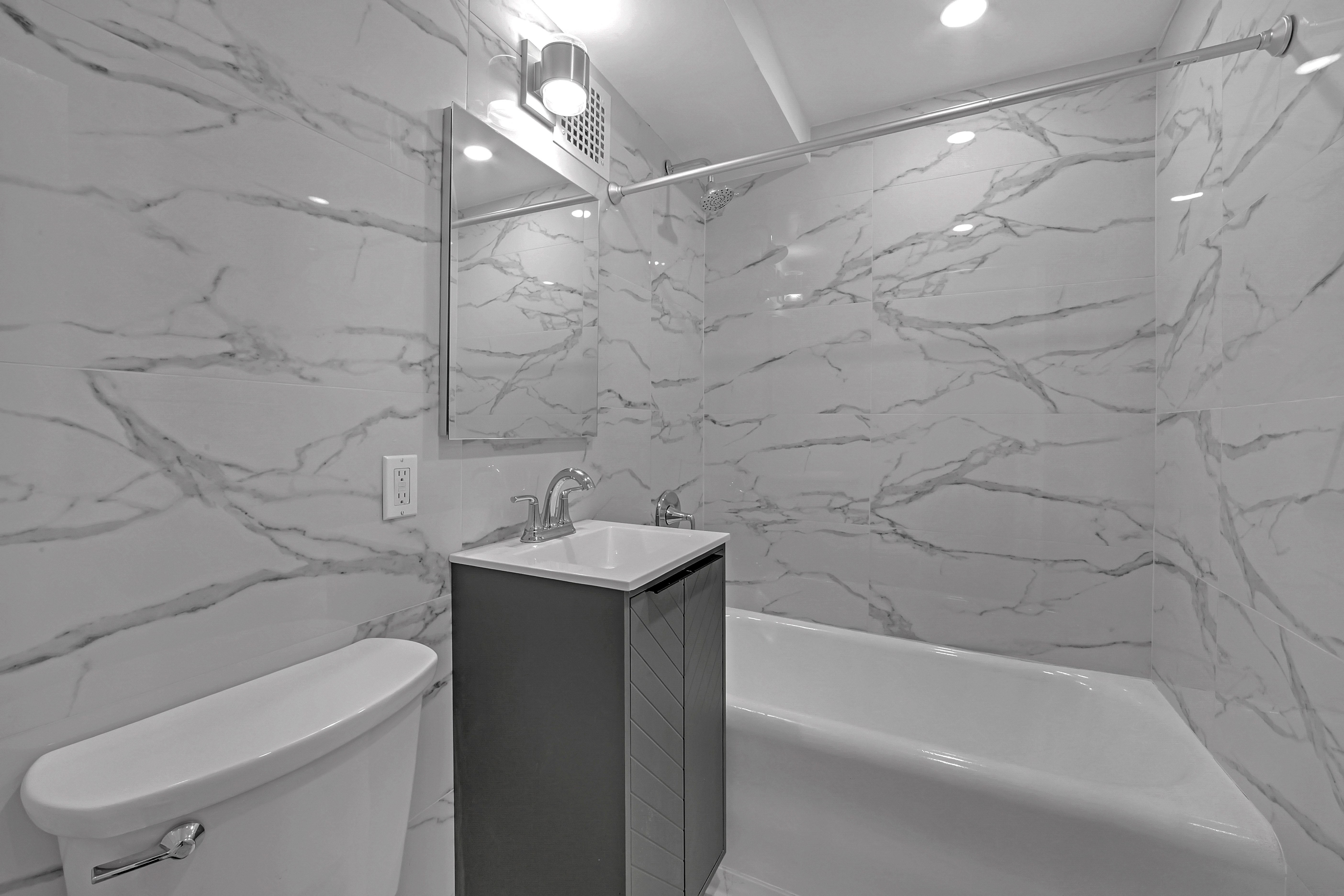 5 Tudor City Place, Unit 536 Manhattan, NY 10017 - Photo 4 of 14 a bathroom with a sink a toilet and shower