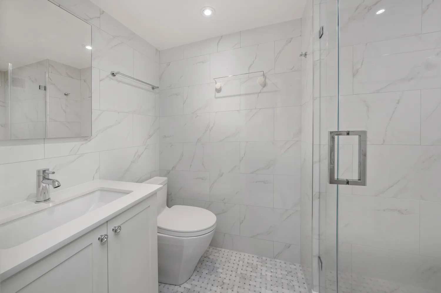 a bathroom with a toilet sink and shower