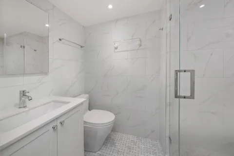 a bathroom with a toilet sink and shower