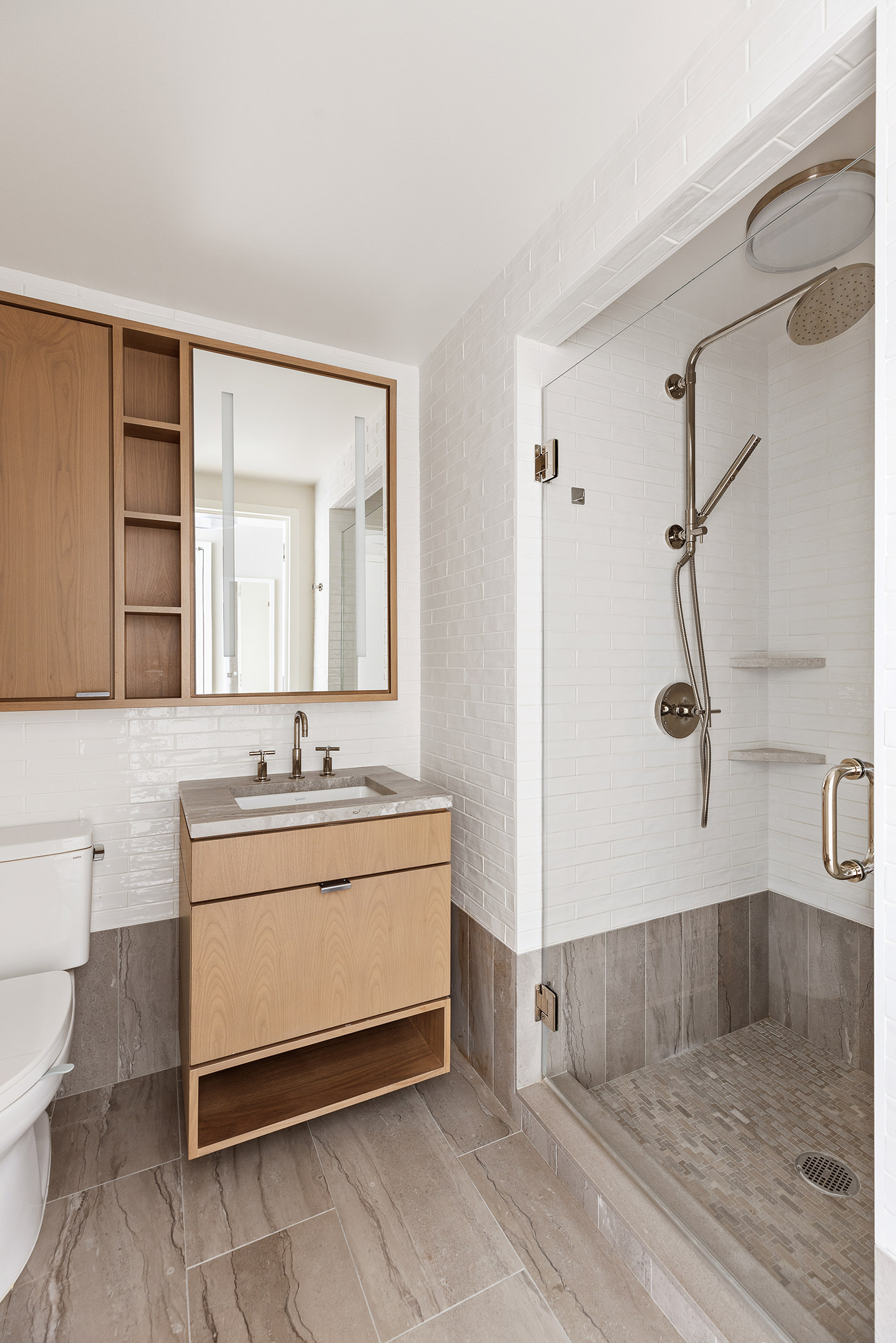 20 River Terrace, Unit 22A Manhattan, NY 10282 - Photo 7 of 27 a spacious bathroom with a double vanity sink toilet mirror and shower