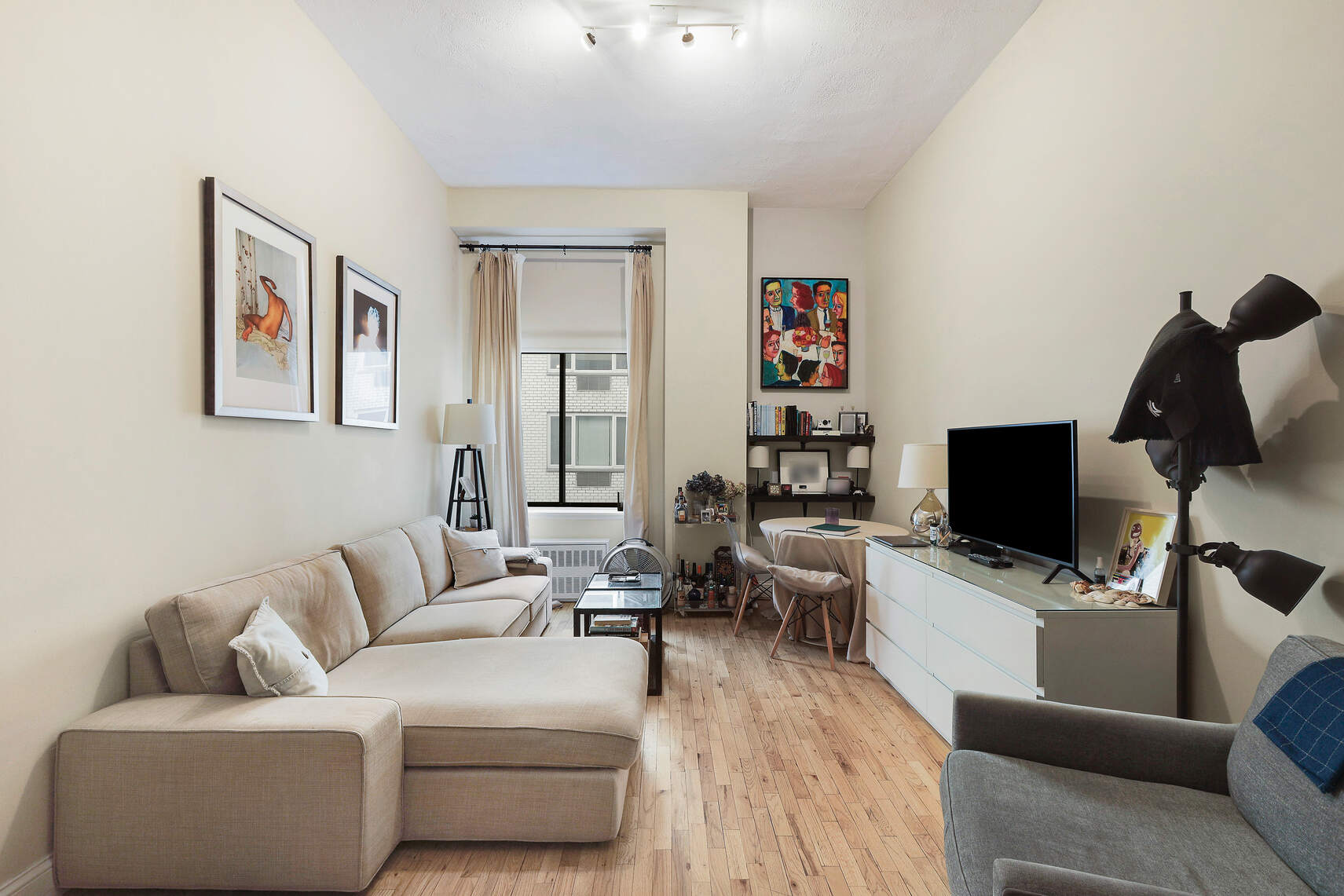 310 East 23rd Street, Unit 7C Manhattan, NY 10010 - Photo 2 of 18 a living room with furniture and a flat screen tv